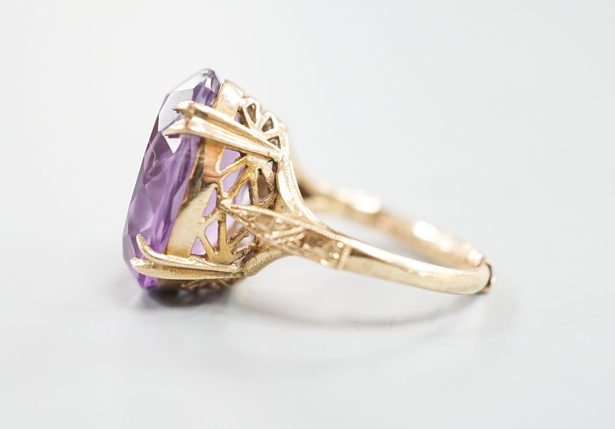 A modern 9ct gold and oval cut amethyst set dress ring, size L/M, gross weight 5.7 grams.